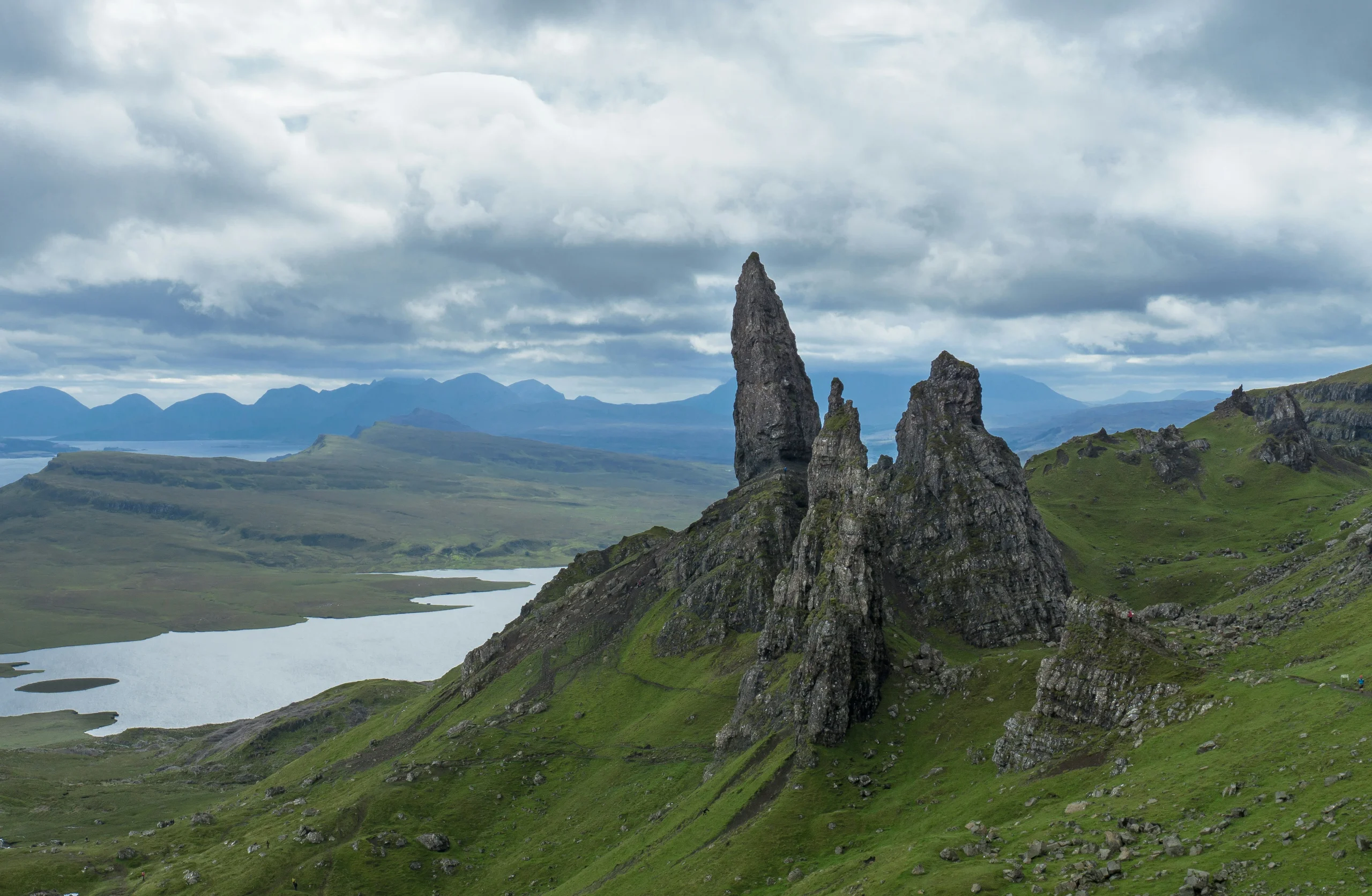The Old Man of Storr rock pinnacle rising above Loch Leathan on the Trotternish peninsula, Isle of Skye