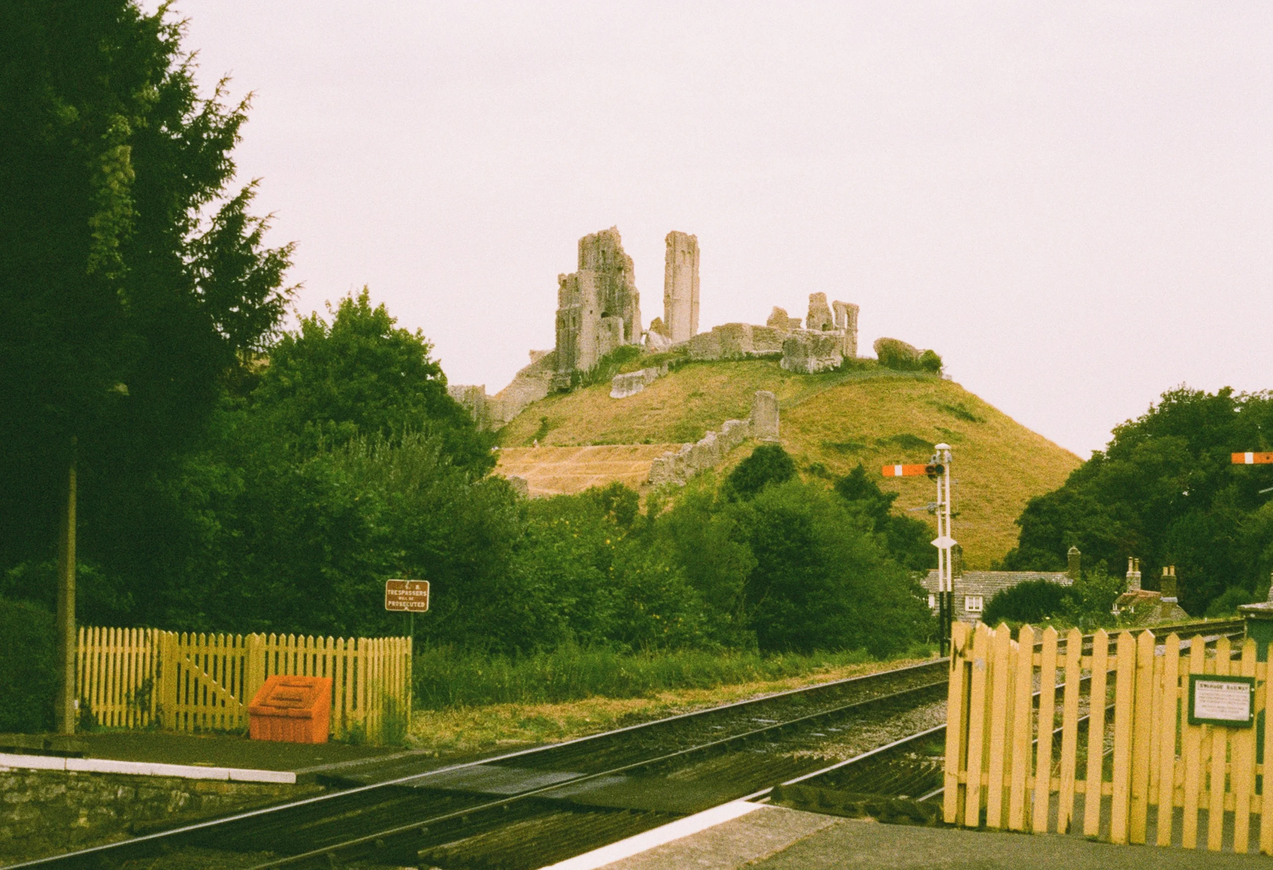 A Swanage Railway steam train passing below the hilltop ruins of Corfe Castle in Dorset