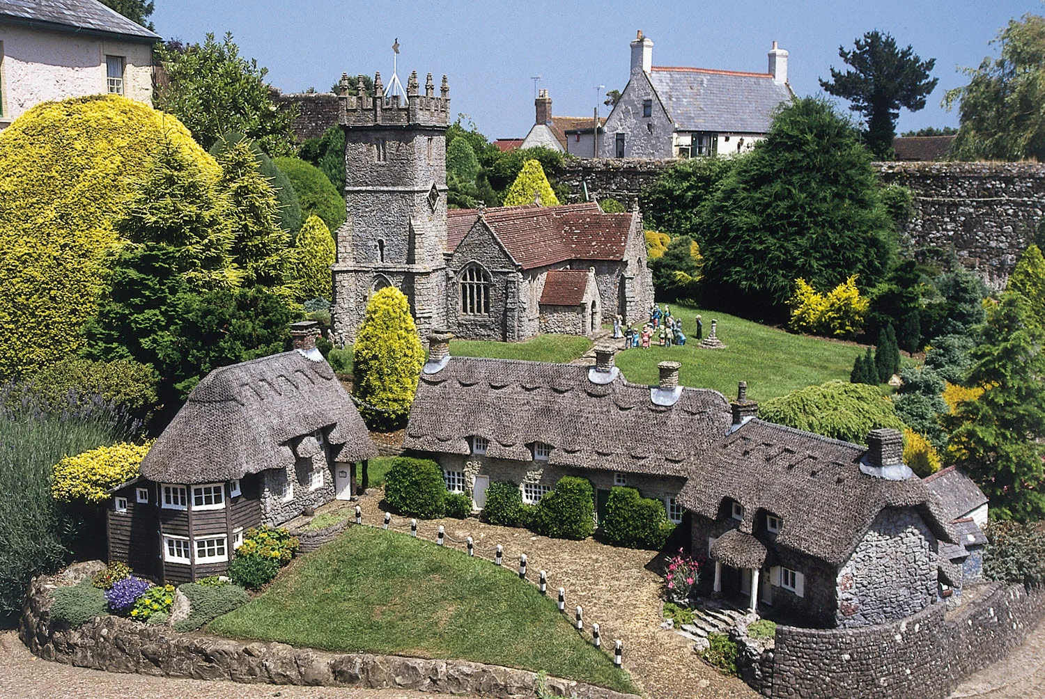 Miniature thatched cottages and a tiny church at Godshill Model Village on the Isle of Wight