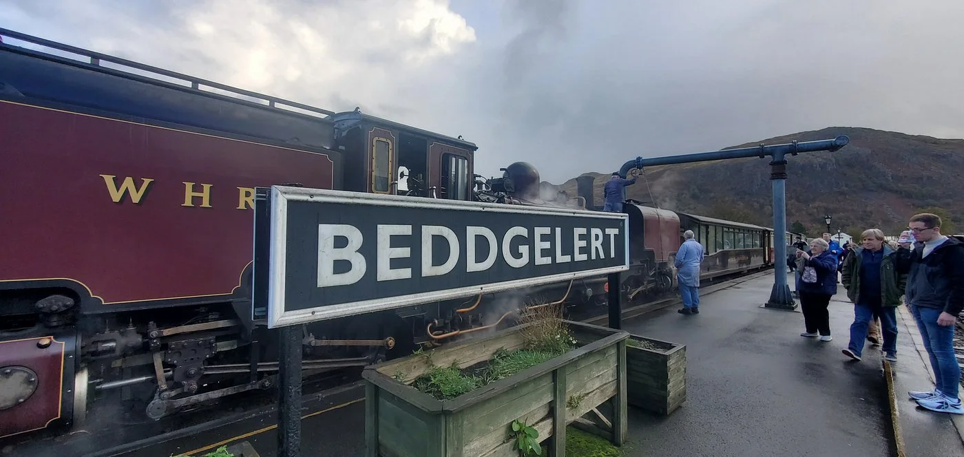 A Welsh Highland Railway steam train at Beddgelert station in Snowdonia, North Wales