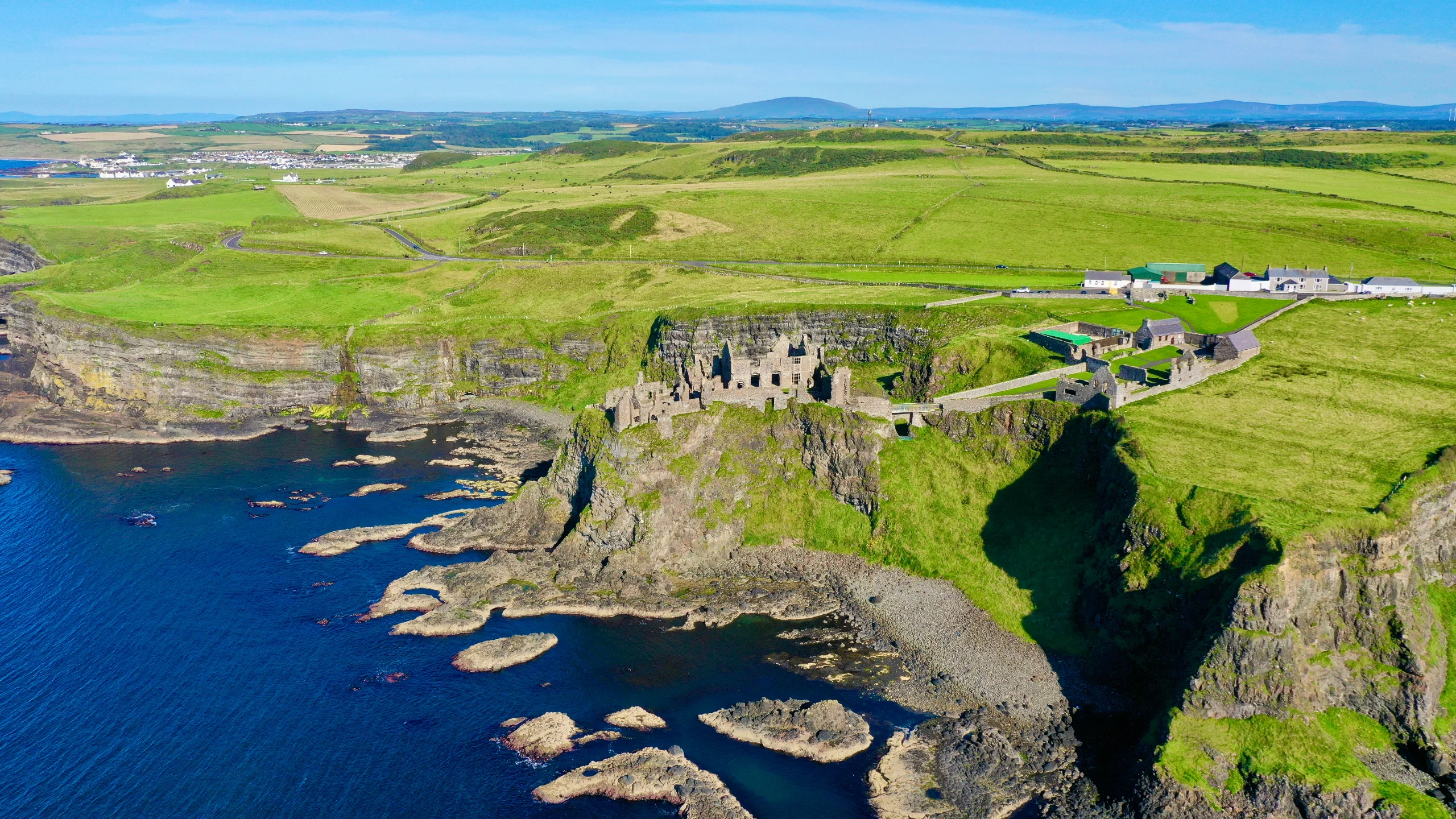 The ruins of Dunluce Castle on the cliff edge above the sea on the Causeway Coast, Northern Ireland