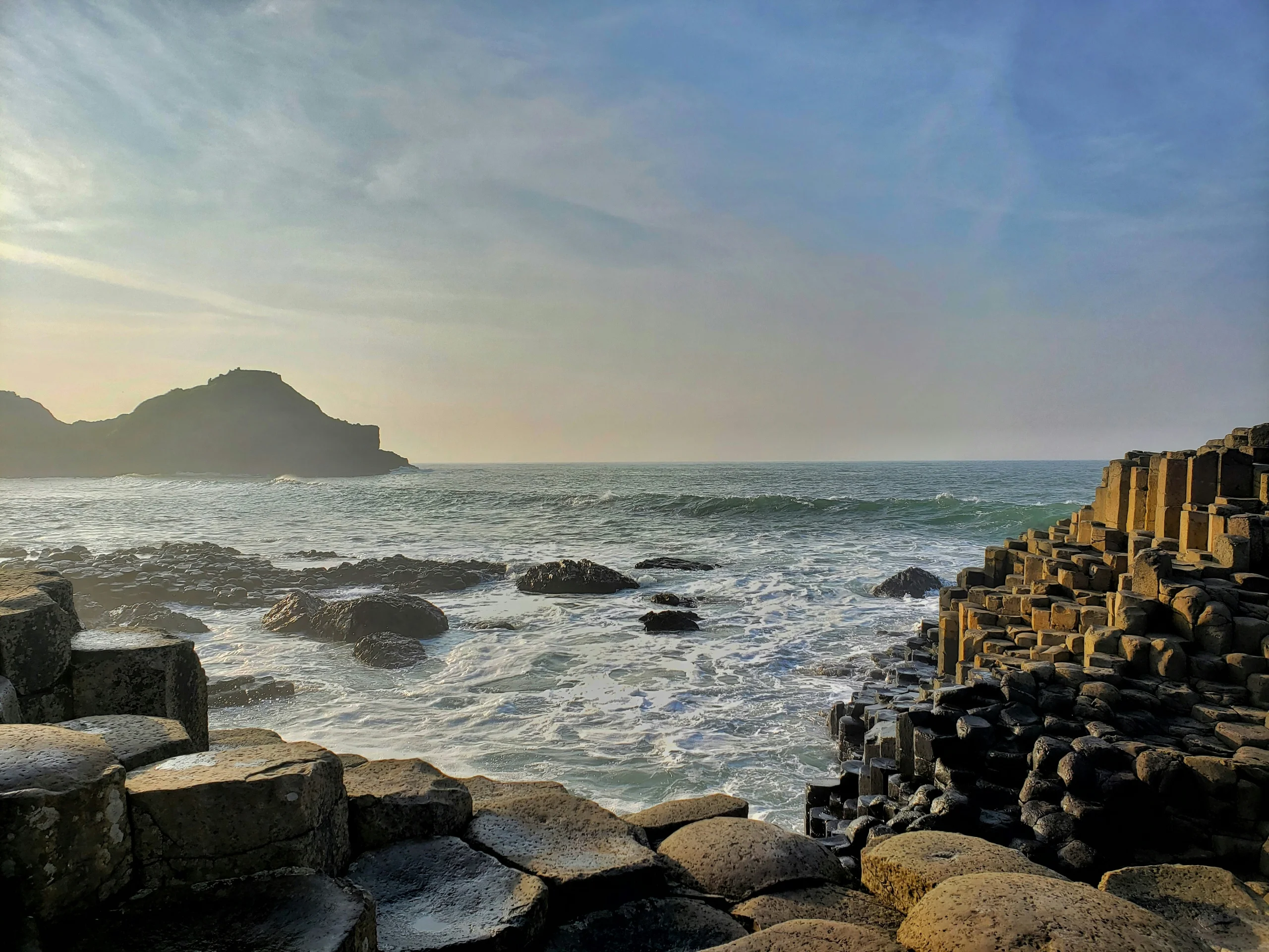 The hexagonal basalt columns of the Giant's Causeway stepping down into the sea in County Antrim, Northern Ireland