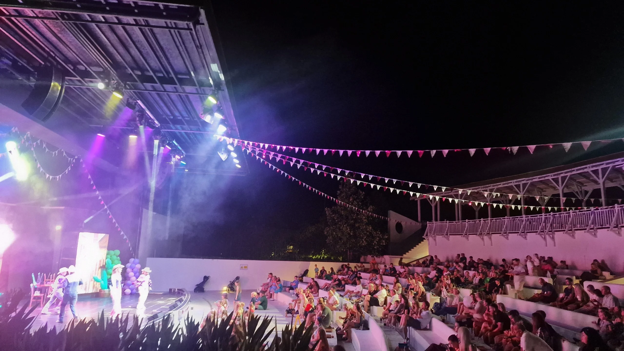 Large stage with lights and bunting with evening entertainment